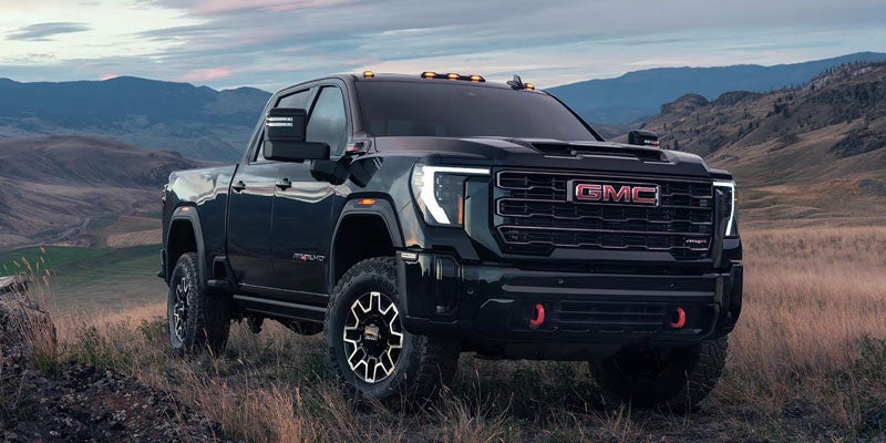 Black GMC pickup truck parked in rugged landscape near HEREFORD, TX at Stevens 5-Star Car & Truck Center GMC dealership.